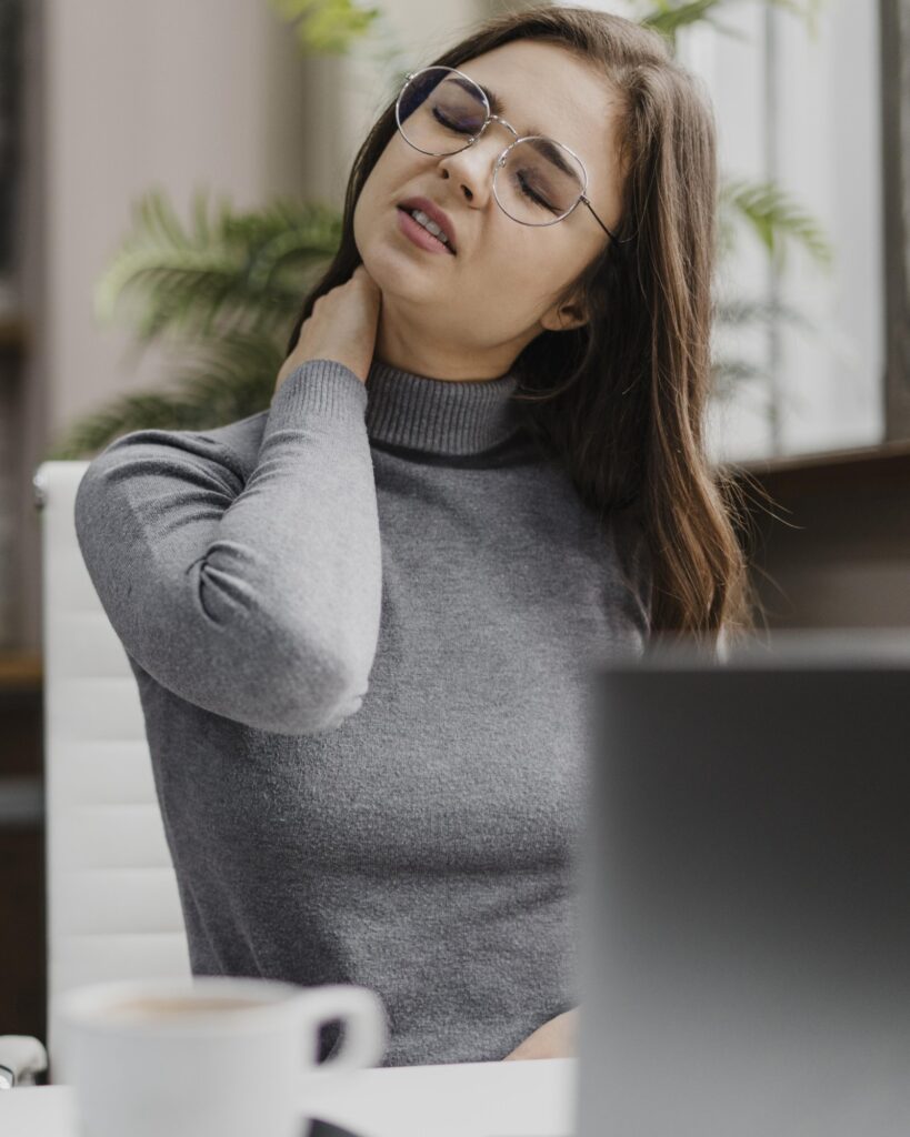 Woman Suffering From Chronic Neck Tension And Stiffness