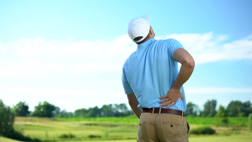 Golfer with back pain who could benefit from infrared sauna recovery